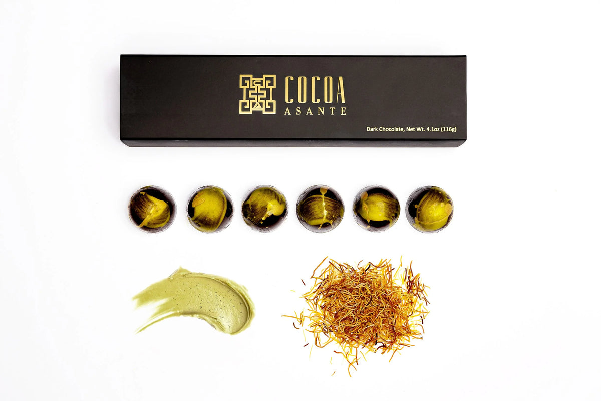 Dubai bonbons in dark chocolate shells painted with shimmering green and gold cocoa butter